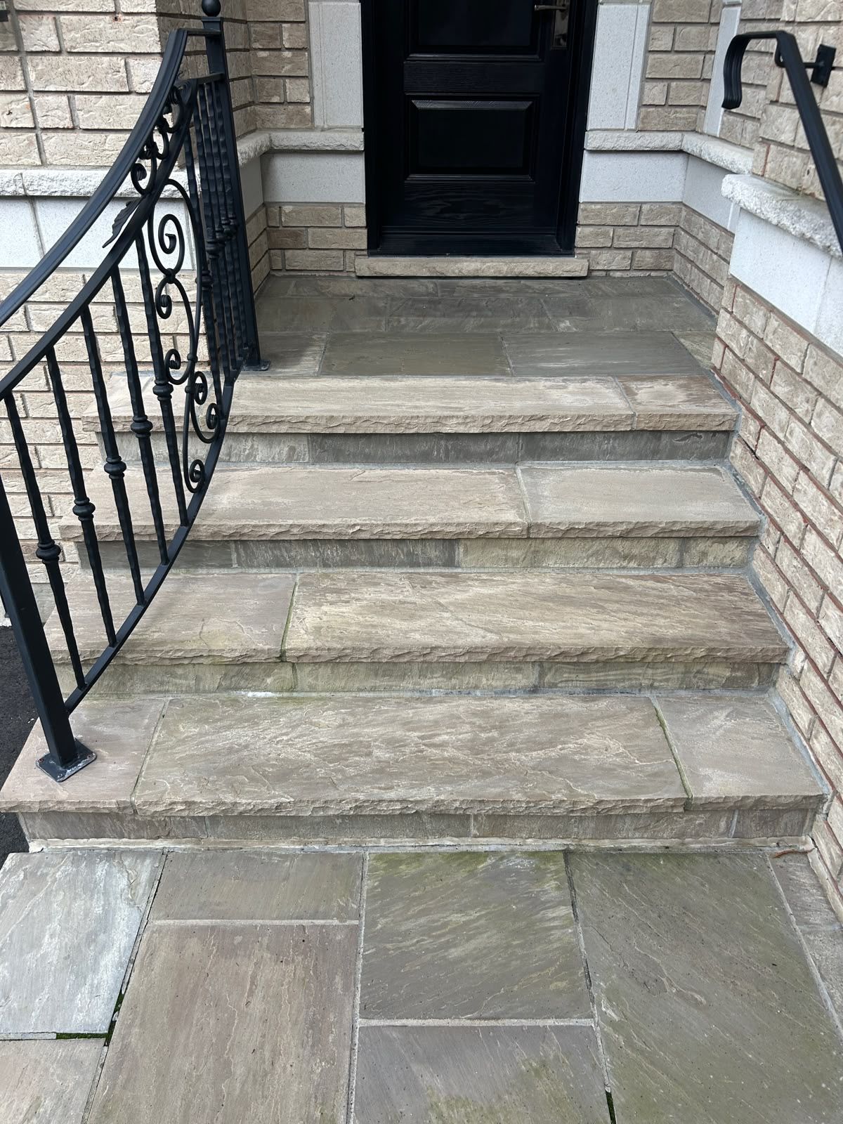 Natural-stone steps with an iron railing