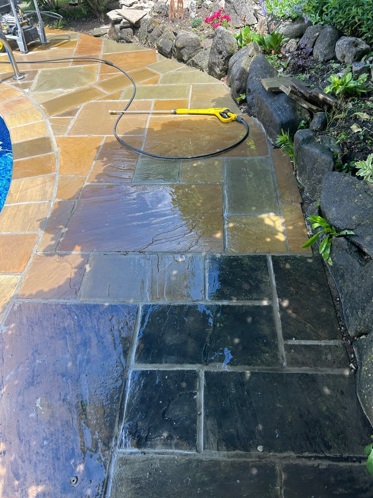 Flagstone walkway part-way through sealing, showing the darker enhanced finish