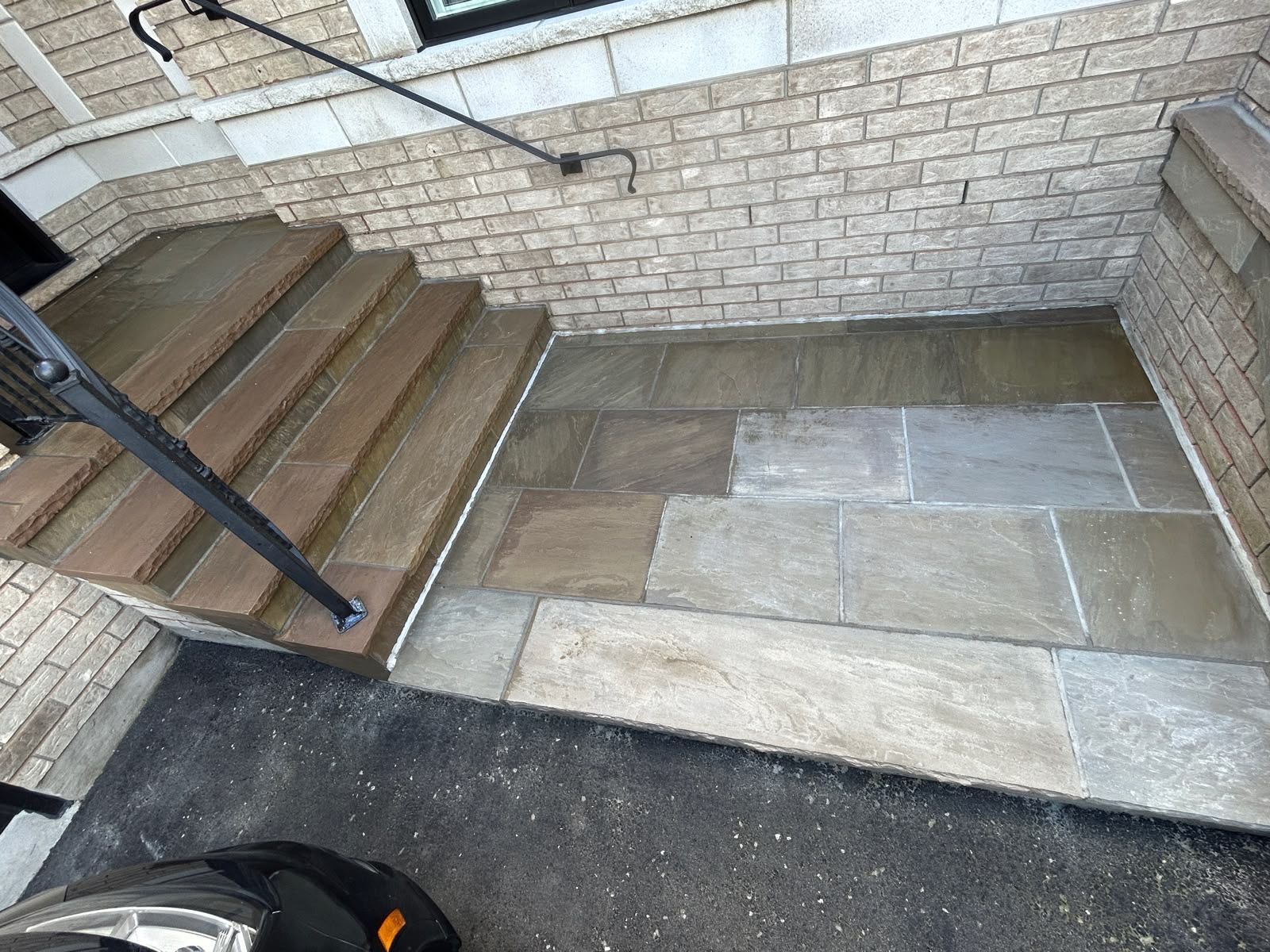 Steps and stone landing in a brick-walled courtyard