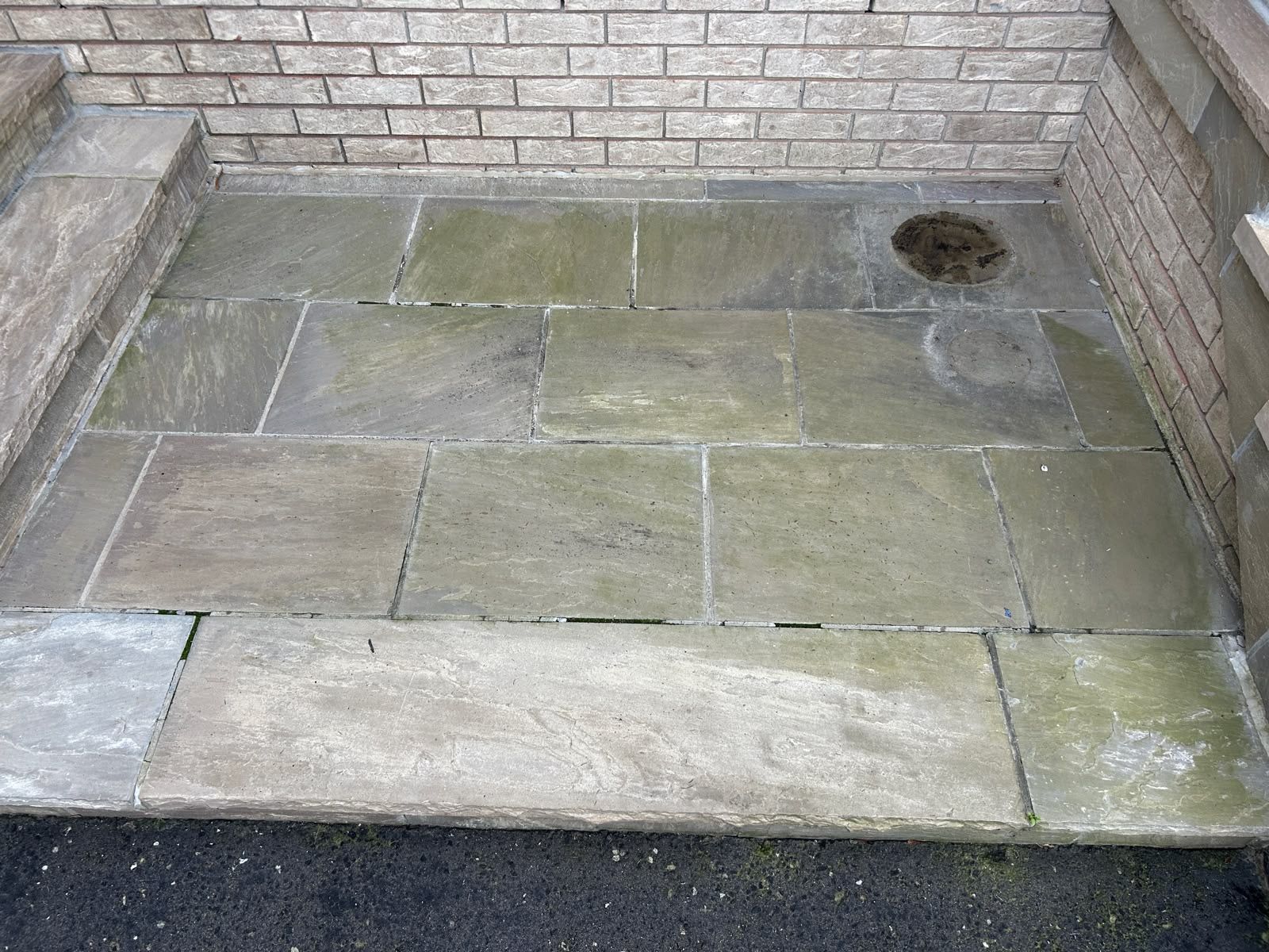 Stone landing against a brick wall