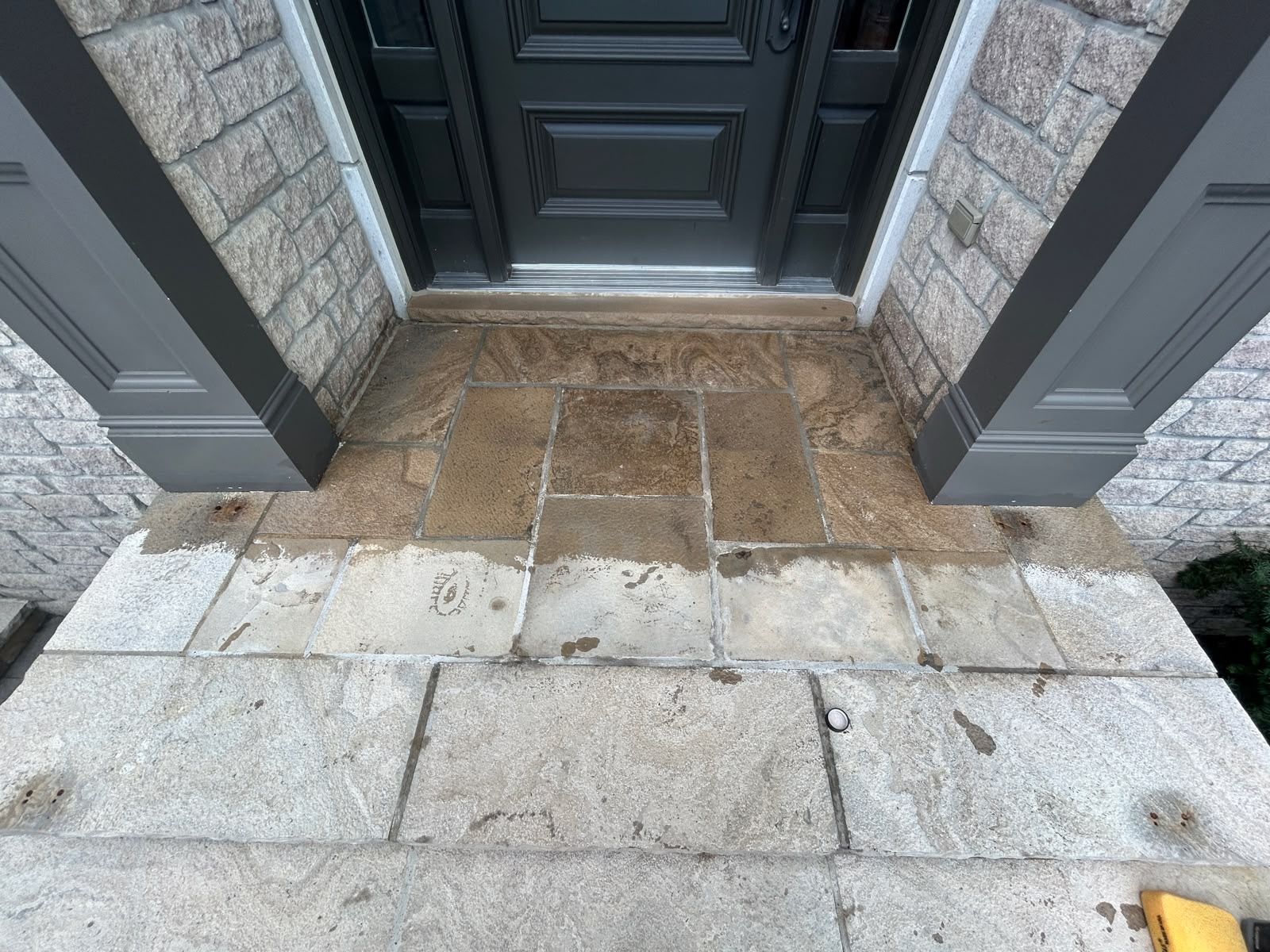 Sandstone entrance landing at a set of double doors